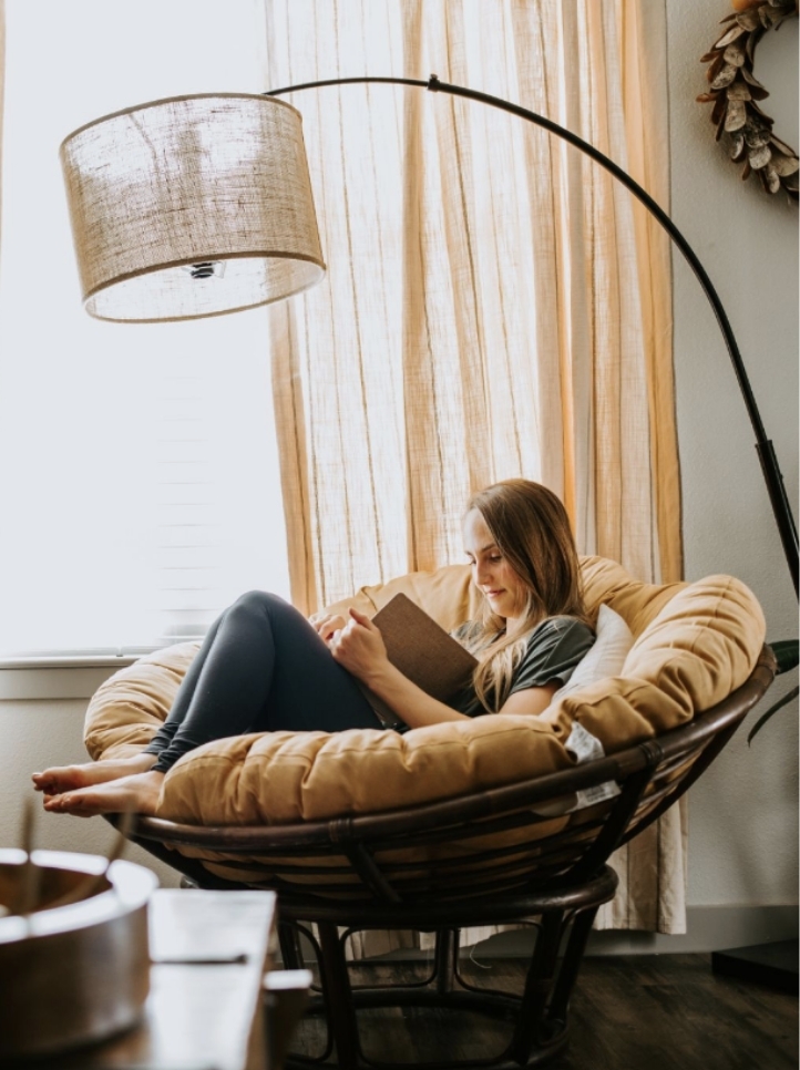 Women comfortably reading in a chair